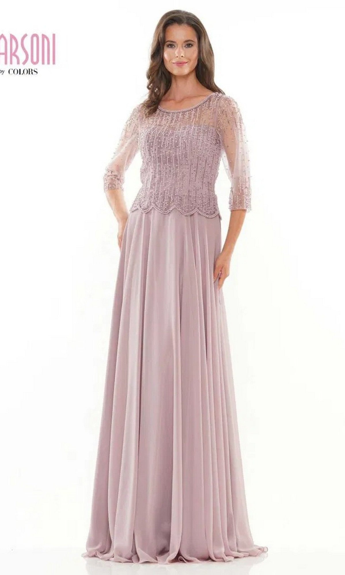 A woman models the Long Formal Dress: Marsoni M312, featuring a beaded bodice, sheer three-quarter sleeves, and an elegant a-line skirt, set against a plain white background.